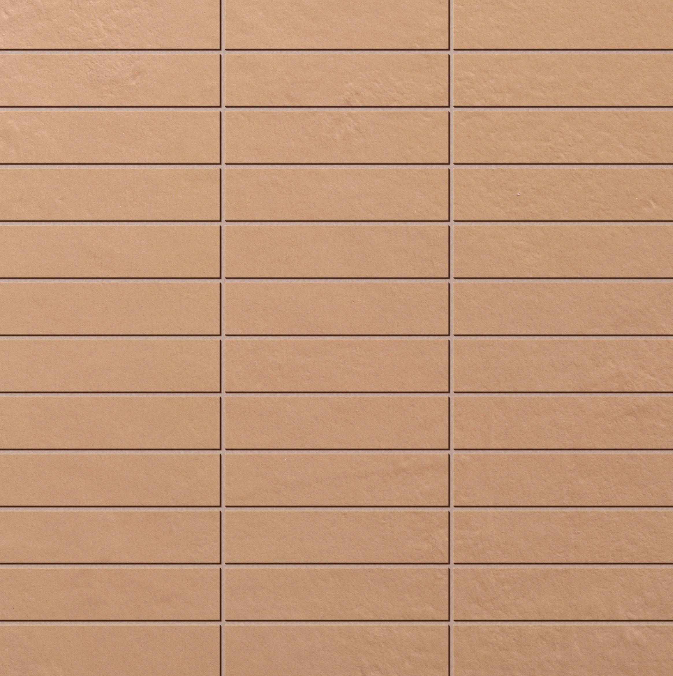 Brick Mosaic Malt: Beige-braune Fliese mit leichter Struktur, unscharf.